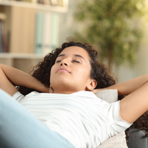 Image of woman laying on chair relaxed.